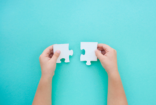 Puzzle pieces on blue background. Autism awareness day. puzzle piece