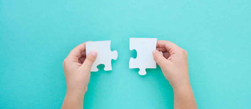 Puzzle pieces on blue background. Autism awareness day. puzzle piece